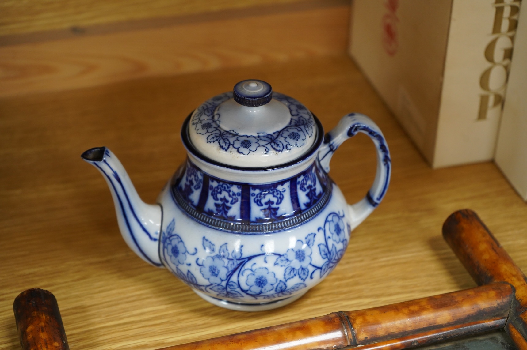 A MacIntyre Burslem blue and white teapot, c.1900, 15cm high and an early 20th century Chinese portrait photograph in a bamboo frame